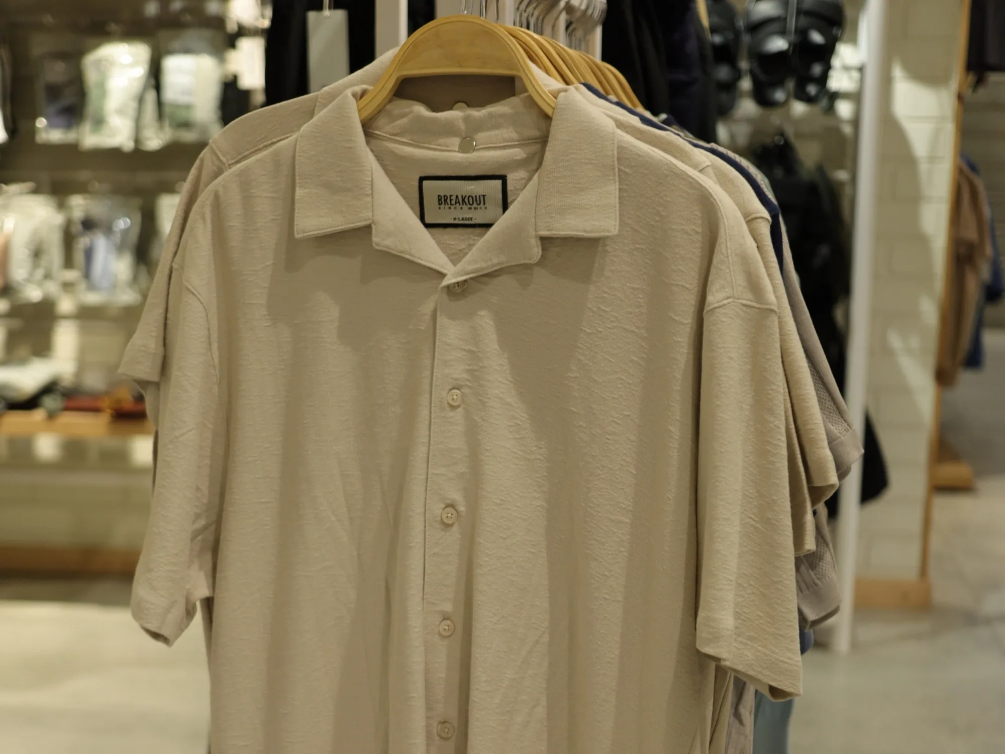 A stone linen shirt on a hanger at BREAKOUT