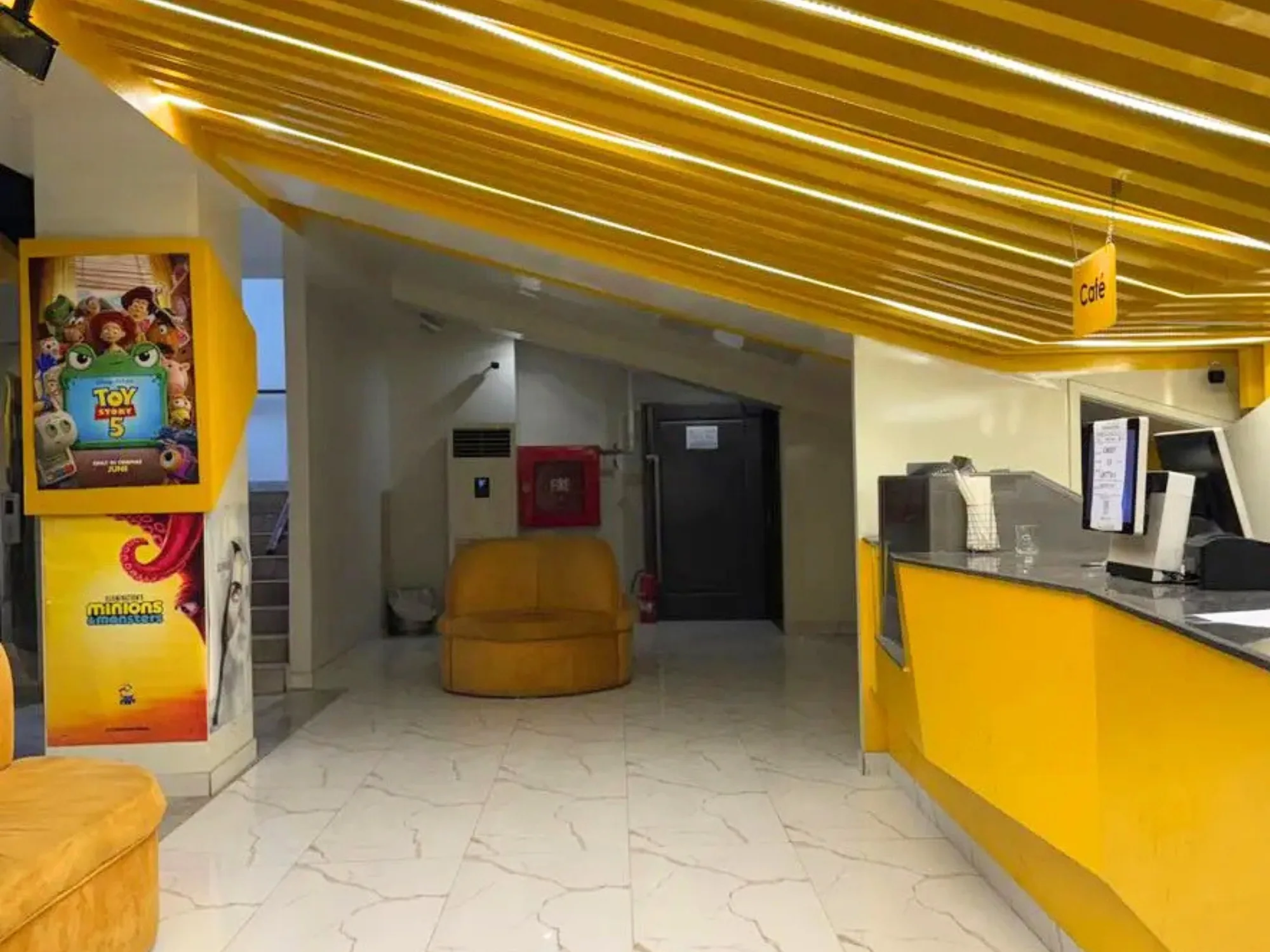 The CineStar concession counter at Xin Mall, lit in yellow beside the foyer