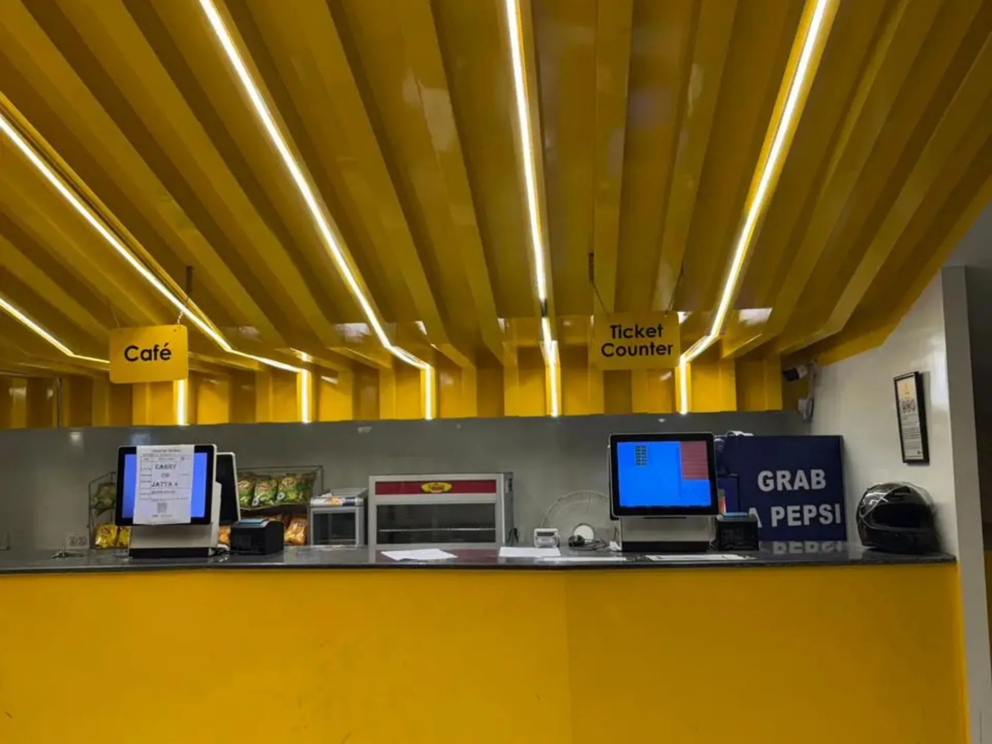 The CineStar ticket and snack counter, tills and menu screens along the yellow bar