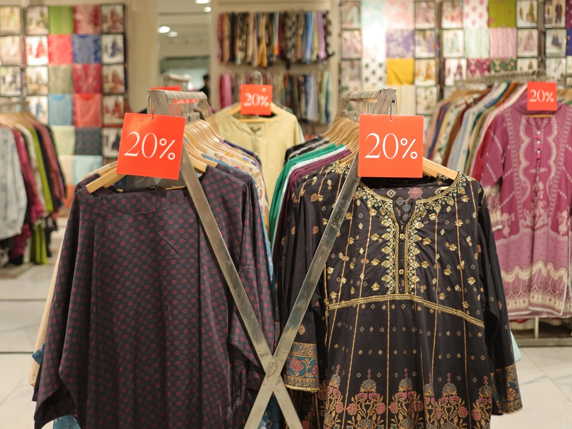 Dark embroidered formals on stands at Limelight, reduced by twenty per cent