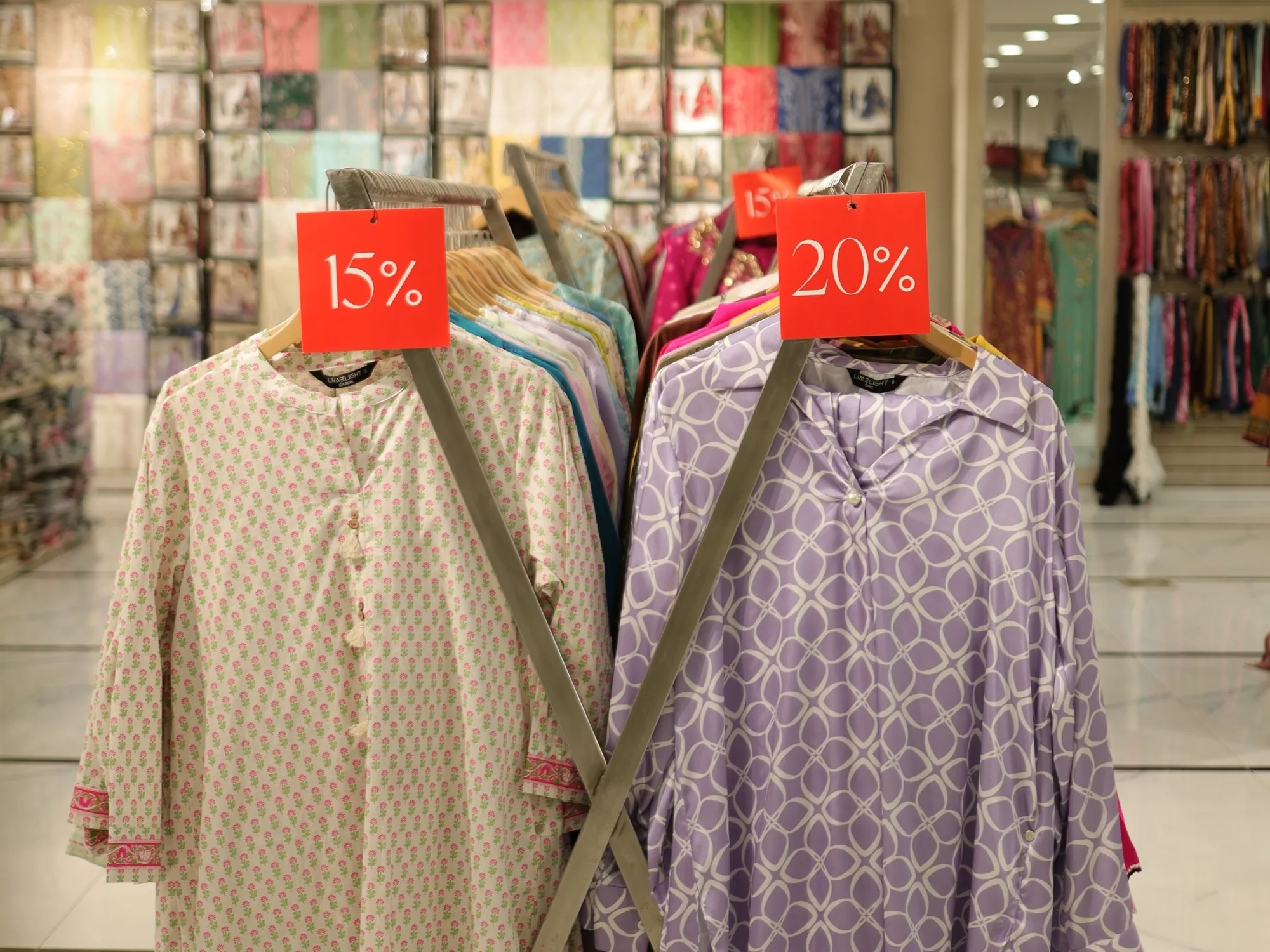 Cream and lilac embroidered suits on stands at Limelight