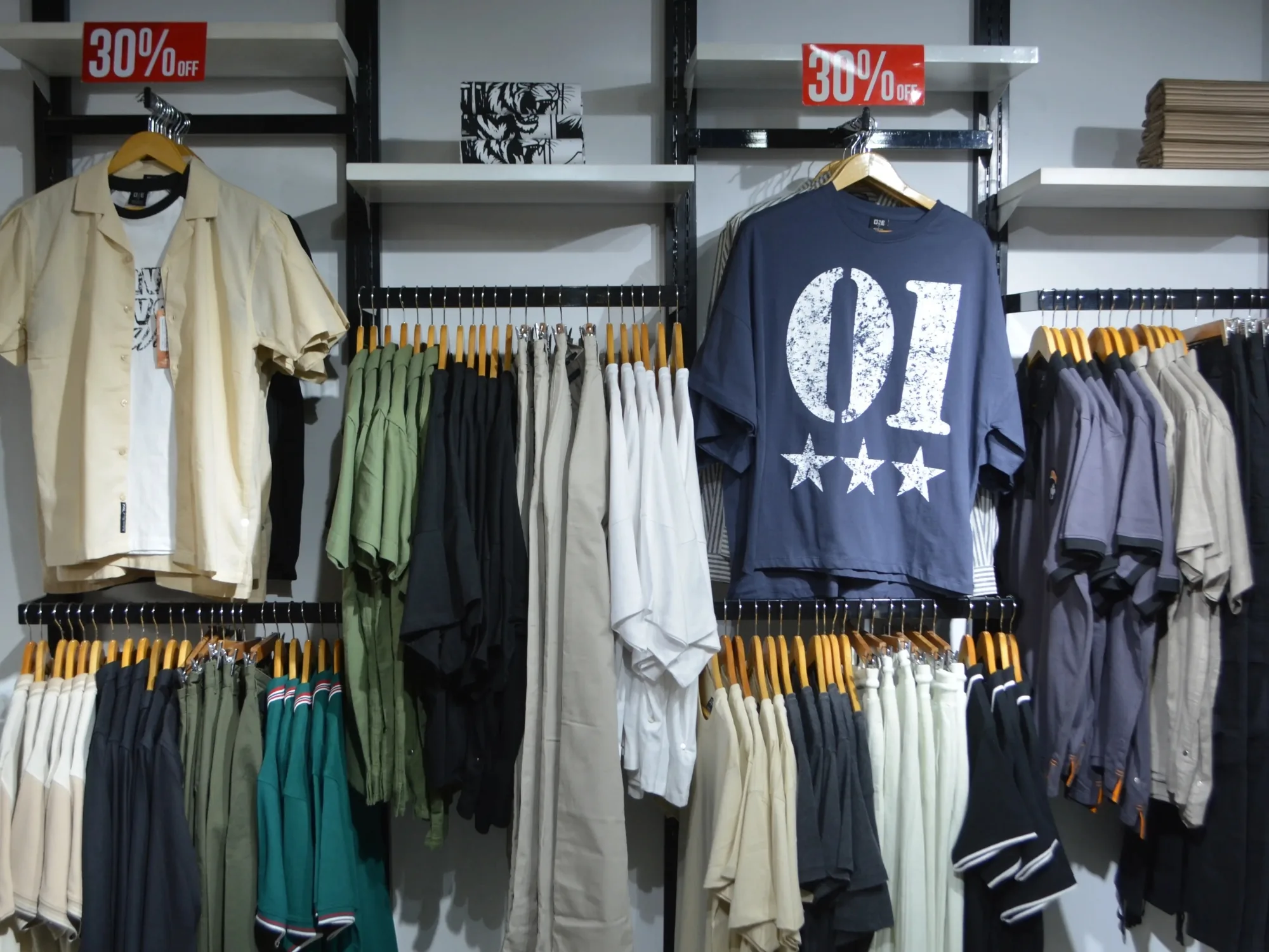 The ONE shop floor at Xin Mall during a sale, rails marked thirty per cent off