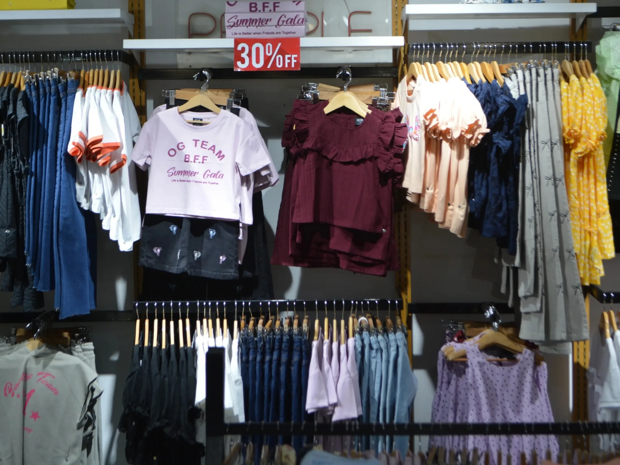 The kidswear section at ONE, printed tees and separates on a rail
