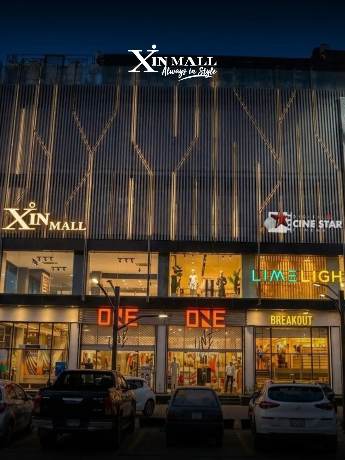 The lit storefronts of Limelight, ONE and BREAKOUT along Xin Mall's frontage