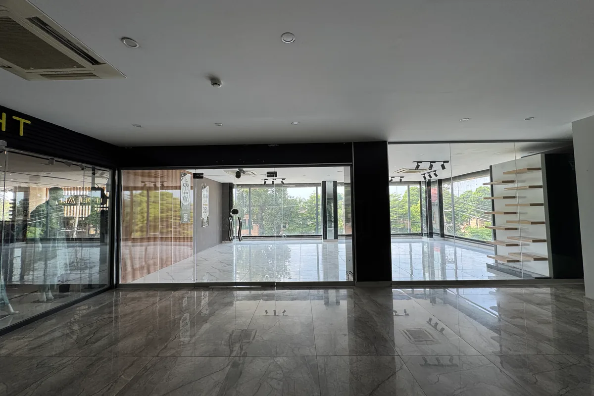 A vacant ground-floor retail unit at Xin Mall, glass-fronted and ready to fit out