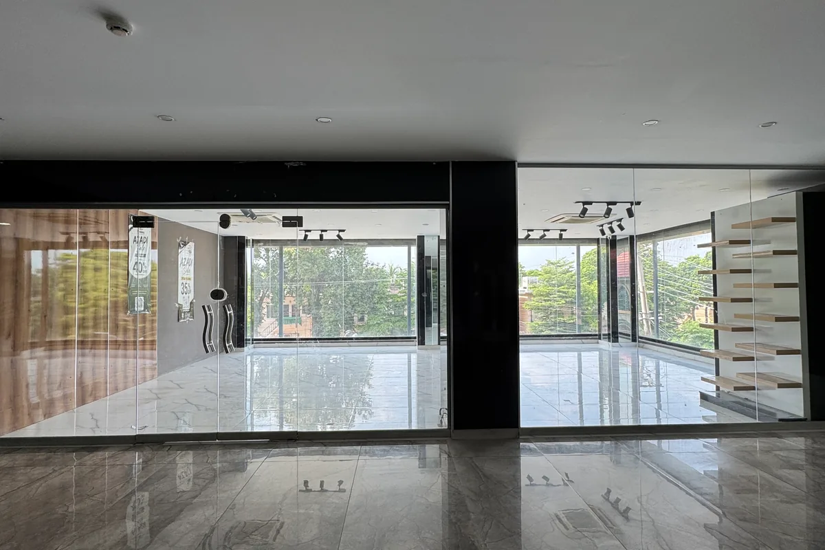 A vacant upper-floor unit at Xin Mall with natural light on two sides