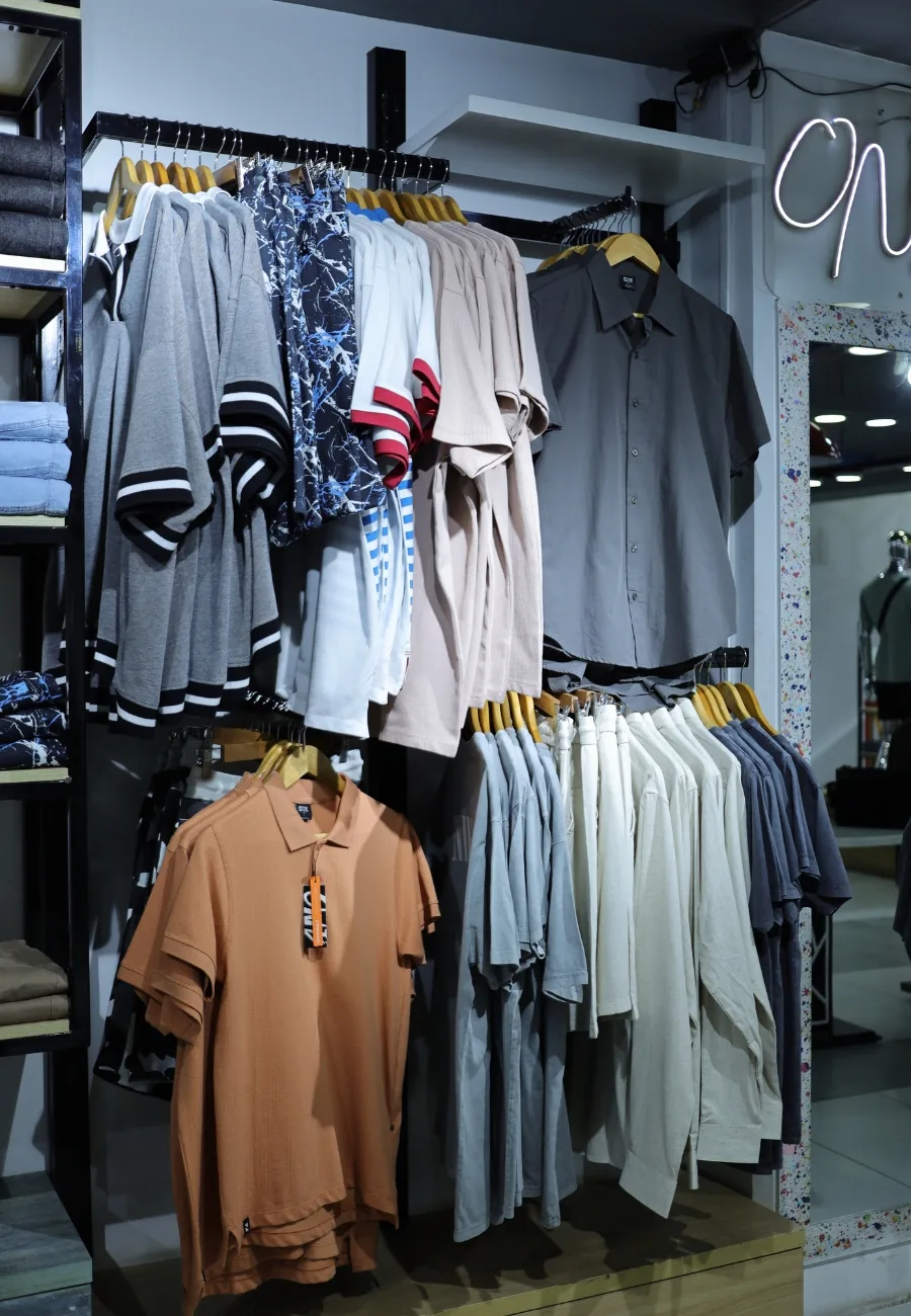 Menswear on the rails at ONE, the brand's neon mark above
